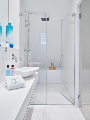 a white bathroom with a sink and a shower at VISIONAPARTMENTS Militärstrasse - contactless check-in in Zürich