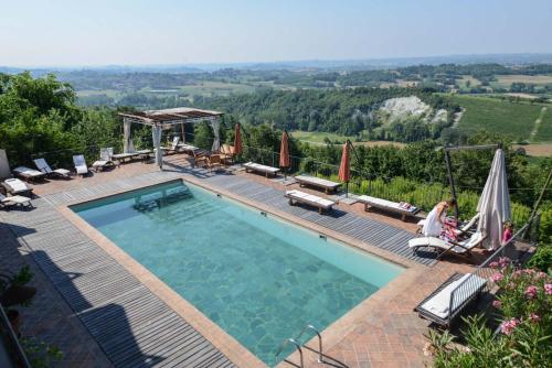 a swimming pool with a view of the countryside at Canonica di Corteranzo in Murisengo