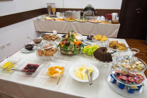 a buffet with many different types of food on a table at Boutique Hotel Kotoni in Tirana