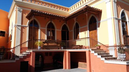 a large building with stairs and a balcony at Pousada Estação do Trem in São João del Rei
