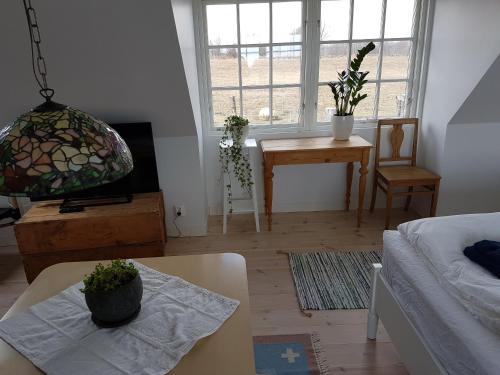 a living room with a couch and a table at Bästekille Gårdshotell in Kivik
