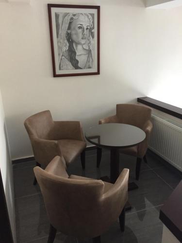 a room with chairs and a table and a picture on the wall at Helen Hotel in Canakkale