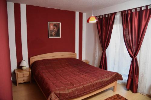 Un dormitorio con una cama con un edredón rojo. en Apartment Mario, en Livno