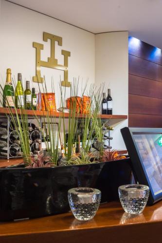 a counter with a bunch of plants and bottles of wine at Teaterhotellet in Malmö