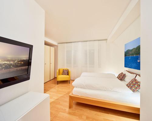 a bedroom with two beds and a flat screen tv at Hotel zur Post in Attendorn