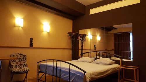 a bedroom with a bed and a chair and lights at Hospitality Centrum- River in Bucharest