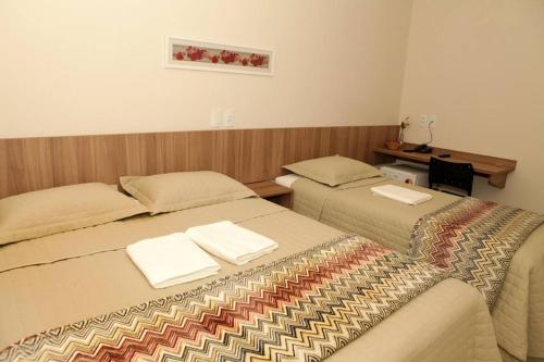 Ένα ή περισσότερα κρεβάτια σε δωμάτιο στο Siena Hotel
