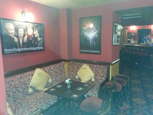 a room with a couch and a table and a tv at Mornington Hotel in Saint Helier Jersey