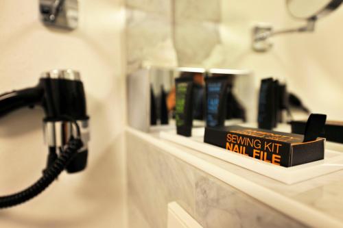 a book sitting on a shelf in a bathroom at Romantik Hotel Meisenheimer Hof in Meisenheim