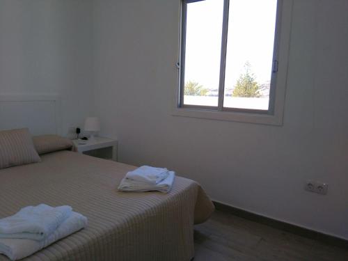 Ένα ή περισσότερα κρεβάτια σε δωμάτιο στο Apartamentos Noda