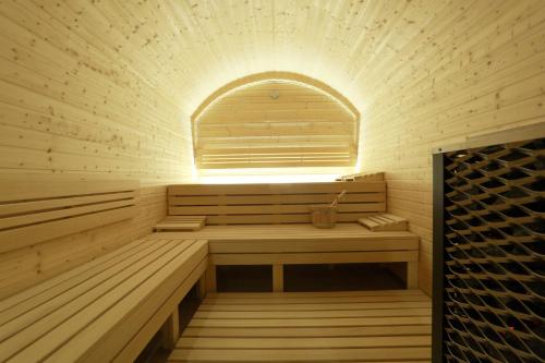 a sauna with a window and a wooden bench at Penzión Wellness & Restaurant Zoborská, free parking in Nitra