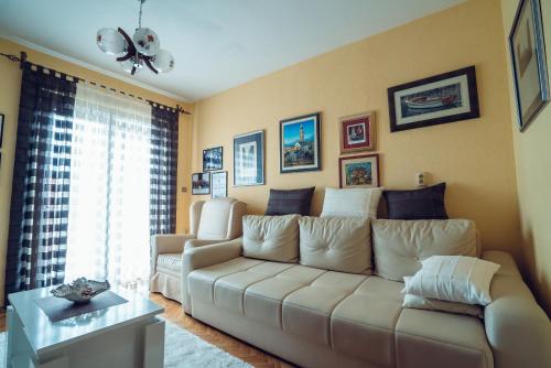 a living room with a couch and a window at Ivica Apartments in Imotski