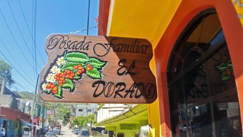 a sign on the side of a store at Posada Familiar El Dorado in Xilitla