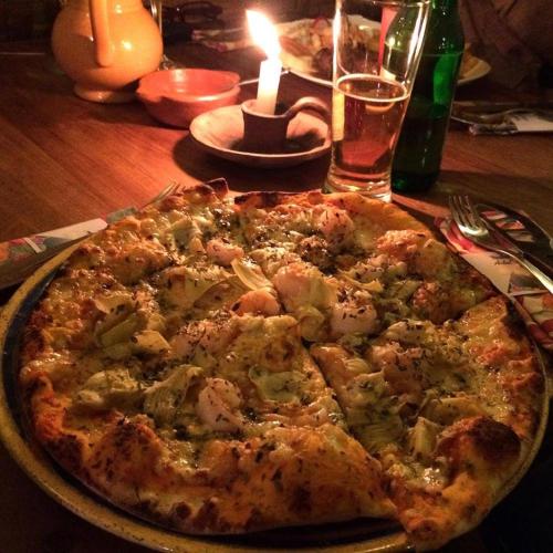 a pizza sitting on top of a table at Hotel Doña Esther in Otavalo