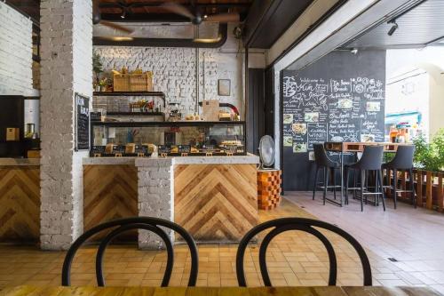 a restaurant with two chairs and a counter with a bar at Kim Haus Loft in George Town