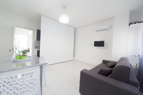 a living room with a couch and a table at Appartamenti DueC in Trapani