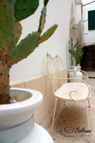 a white chair sitting next to a potted plant at I Sottani in Monopoli