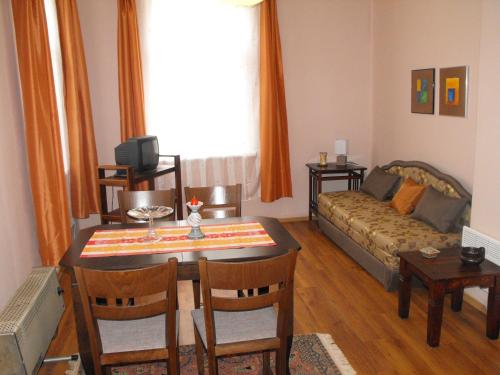 a living room with a table and a couch at Julia Garden in Burgas City