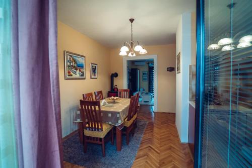 a dining room and kitchen with a table and chairs at Ivica Apartments in Imotski