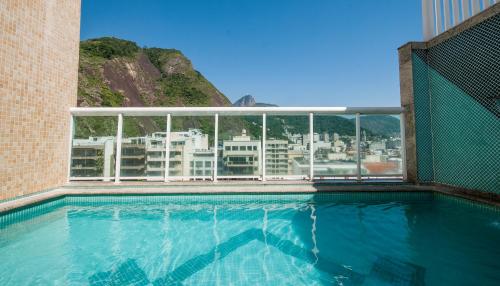 a swimming pool with a view of a city at Hotel Bandeirantes in Rio de Janeiro