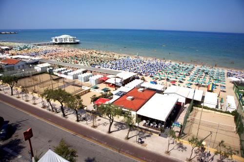 a crowded beach with a large crowd of people at City Hotel in Senigallia