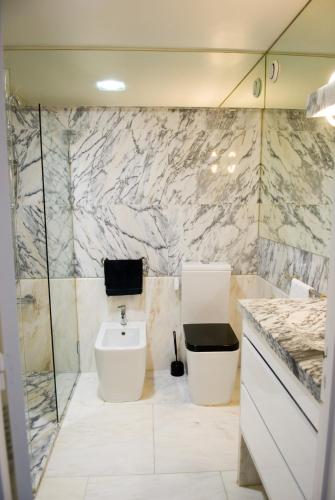 a bathroom with a sink and a toilet in it at Porto Sea Apartments in Matosinhos