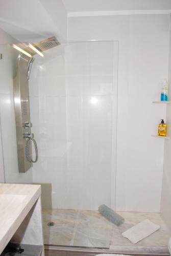 a shower with a glass door in a bathroom at Porto Sea Apartments in Matosinhos