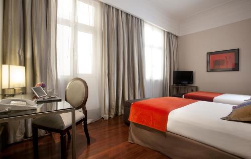 a hotel room with a bed and a desk at Savoy Hotel in Buenos Aires