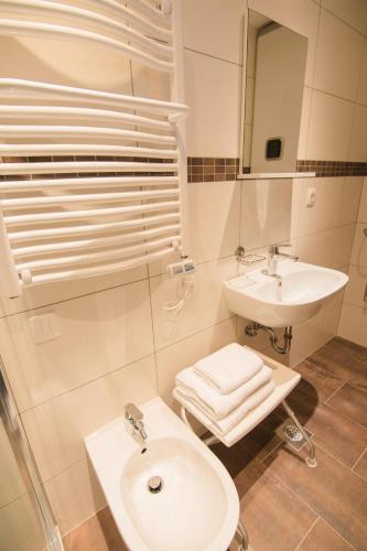 a white bathroom with a sink and a toilet at Apartment Vita in Rab