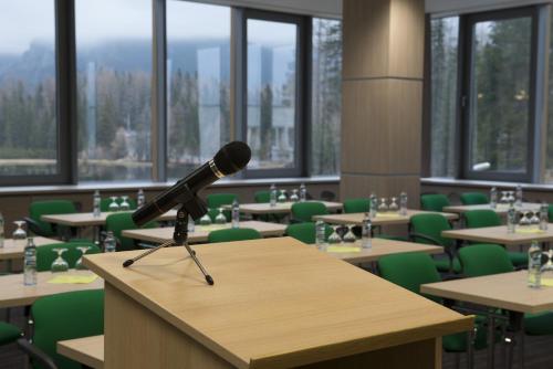 a microphone on a table in a room with tables and chairs at Hotel SOREA TRIGAN in Štrbské Pleso