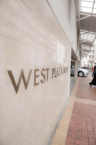 a sign on the side of a building at West Plaza Hotel in Wellington