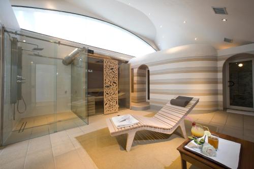 a bathroom with a shower and a bench and a table at Albergo dell'Agenzia in Bra