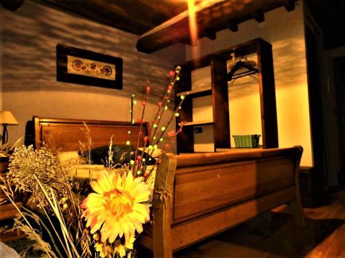 a bedroom with a bed and a mirror and flowers at Casa Rural Amparo in Mogarraz