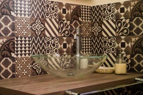 a bathroom with a glass bowl sink on a counter at Il Marrondindo Bed & Breakfast in Galliano