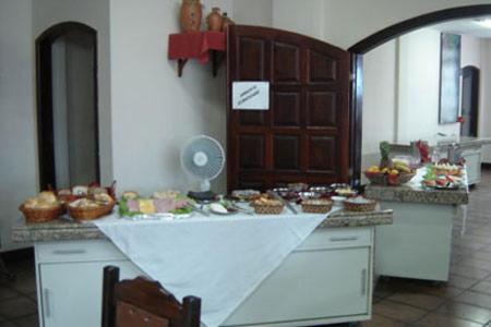 a kitchen with a counter with cupcakes on it at Hotel Zibamba in São Francisco do Sul