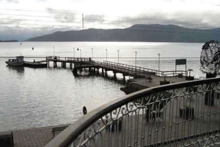a pier with a boat on the water at Hotel Zibamba in São Francisco do Sul