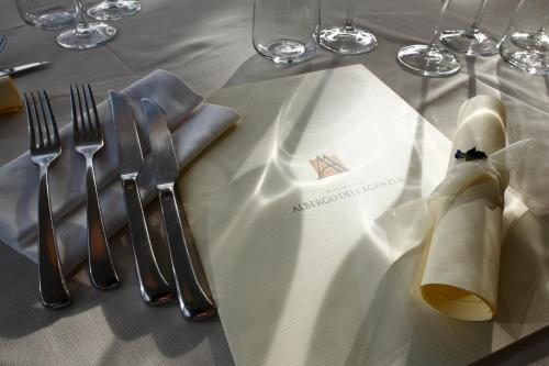 a table with silver utensils on a white table cloth at Albergo dell'Agenzia in Bra