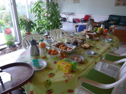 a table with a yellow table cloth with food on it at Clos Muneau in Aiguillon