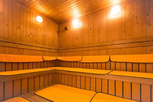 a sauna with benches and lights in it at Hotel Global View Hakodate in Hakodate