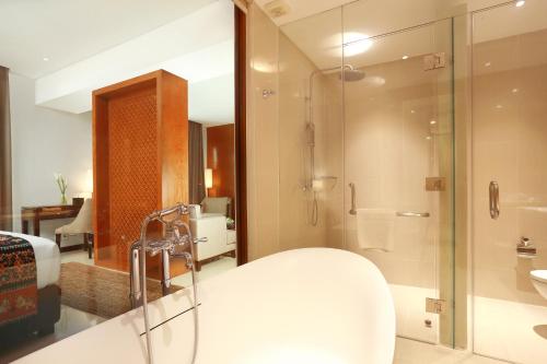 a bathroom with a shower and a sink at Wimarion Hotel Semarang in Semarang