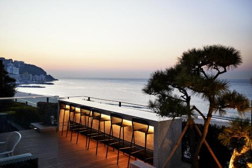 a building with lights on it next to the ocean at Paradise Hotel Busan in Busan