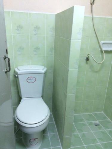 a bathroom with a toilet and a shower at Earth Mansion Sai 5 in Sam Phran