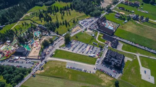 an aerial view of a park with a lot of cars at Borowy Dwór- Biznes, Spa & Fun in Szaflary