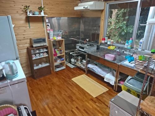 a kitchen with a sink and a counter top at Huuran in Nakijin