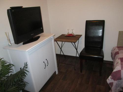 a living room with a tv on top of a dresser at Penzion Lamberk in Nový Jičín