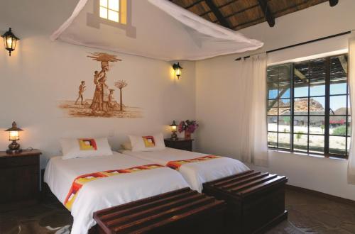 A bed or beds in a room at Gondwana Canyon Village