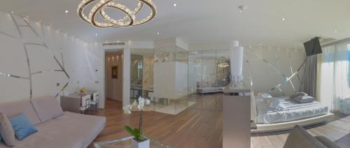 a living room with a couch and a chandelier at Park Hotel Imperial in Limone sul Garda