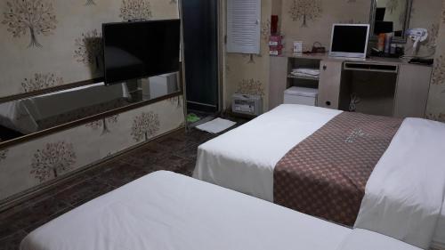 Postel nebo postele na pokoji v ubytování Songdo Blue Hotel