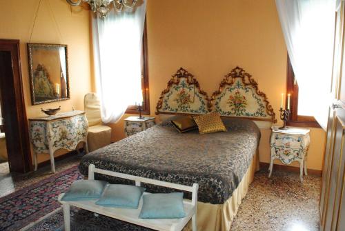 a bedroom with a large bed with blue pillows at B&B San Firmino in Venice
