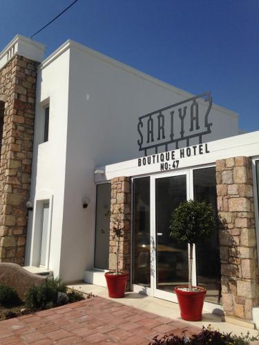 a white building with a sign for a hotel at Costa Sariyaz Hotel Bodrum in Bodrum City